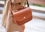 The ONA Palma Camera Satchel closeup of front being worn