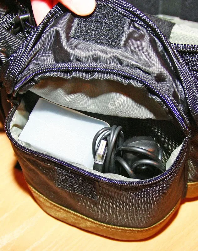On Left..Flashlight diffuser. ...under... 2 sets on AA batteries (in AA boxes) for the flashlight. On Right Wired remote. USB cable. ...under... Back lens cap and mount cap