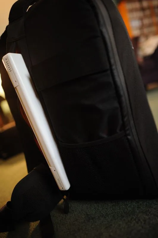 Space for a laptop. I would stow the power supply in the orange zip pocket inside the bag cover.