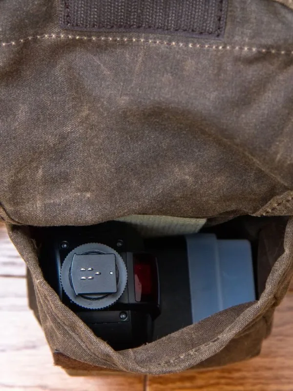 Metz 58 AF-1 in one side pocket. Head tilted to "L" shape. Similar in size to the 580EX II