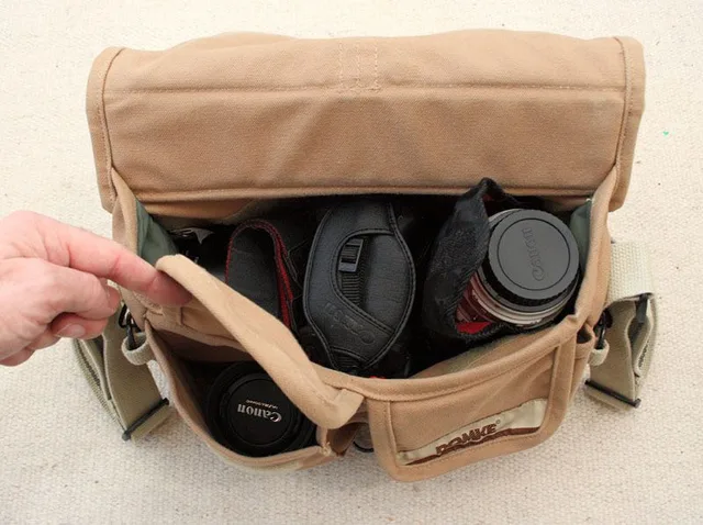 Final pocket holds the 50mm 1.4, with a rubber hood attached.