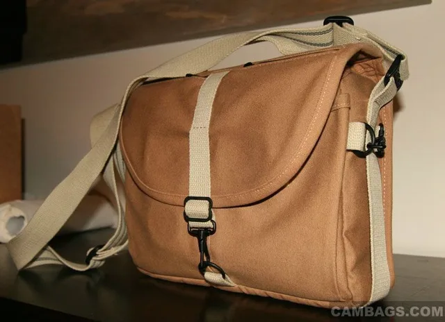 One of the things that makes this bag look less like a camera bag, IMO, is the thickness. At only 4.6" thick (exterior) it looks a lot more like a regular shoulder bag for carrying papers and stuff: