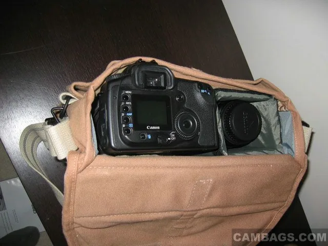 In the side compartment, a 50 1.8 goes at the very bottom. A padded spacer goes on top of it and a 10-22 sits on top (gotta have wide-angle!). The Canon EOS 20D (w/ Sigma 18-50mm EX f/2.8 lens attached) sits on top of the padded spacer in the main compart
