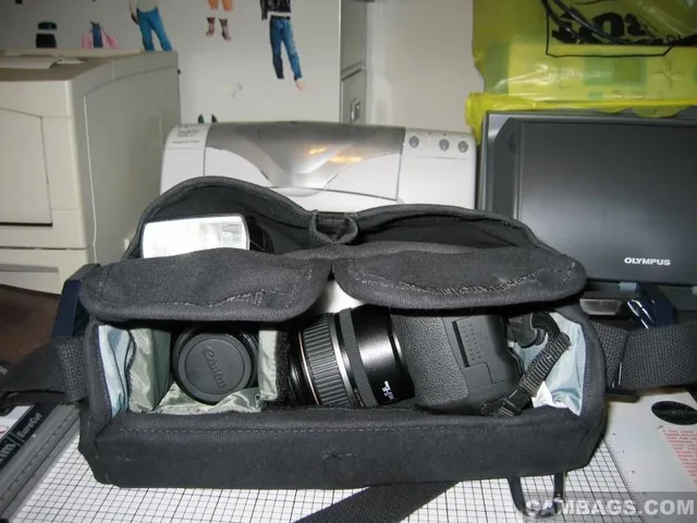 Lots of add'l storage in two front packets. On the left is a Canon 580EX Speedlite flash, which fits flush with top of pocket. Other pocket, I keep add'l batteries, or whatever. CD cards, I usually keep in front zippered pockets on flap.