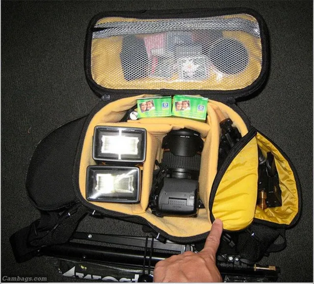 The W94 holds almost as much as the backpack! There's not as much spare room in the W94 but it's roomy enough for camera with lens, 2 flashes, 2 umbrella adaptors, super clamp, gels, filter, battery and cards.