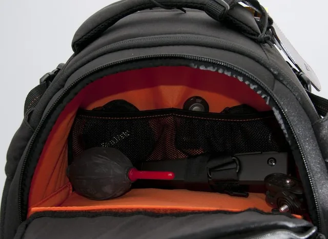 This is the top compartment of the bag. It can be accessed by a zipper on the front of the bag. The size is about 27cm wide, 10cm deep and 14cm height. Enough room for accessories and a flash or a bottle of drink and a light coat.