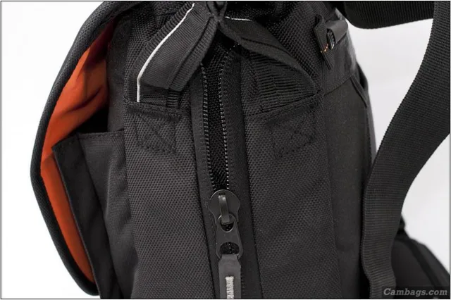 Behind the shoulder strap attachment is a zipper. This is the Up-Rise feature. Opening this zipper gives an extra inch or so depth. This pretty much allows you to add the laptop to the bag without losing any size to the camera compartment. It would also a