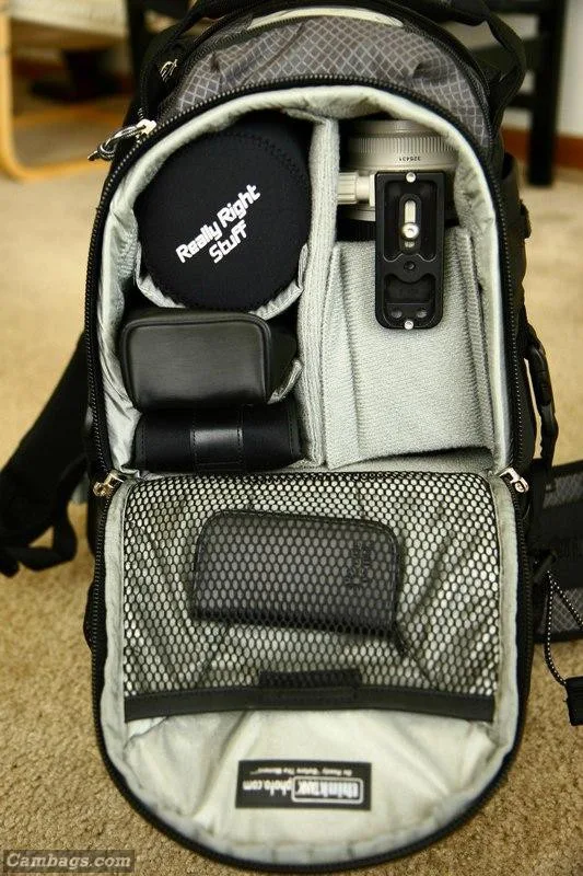 The inside of the top compartment is lined with Velcro loop material, allowing you to position hook dividers in any configuration. In the photo below, you can see I’ve got my 70-200 with hood reversed, RRS BH-40, 580 EX flash, and an Epson 2000.