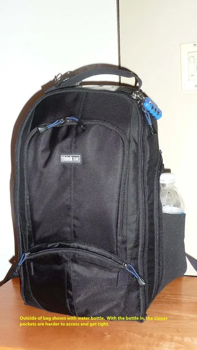 outside of the bag with a water bottle in the side stretch pocket. Each side of the bag has a zipper pocket and a stretch pocket (where the water bottle is). If the bottle is in the stretch portion, the zipper portion is hard to access and you can't put a