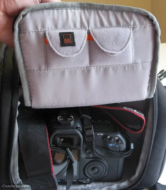The inside of the flap on the main camera compartment contains two storage pockets for your media (compact flash cards DO fit!)
