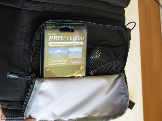Beneath the flap at the bottom of the bag (which is secured by two clip straps which keep the bag from opening up completely and spilling out the contents!) is another outer pocket that has two mesh pockets inside that can be used for storage of remotes, cables, filters, etc.