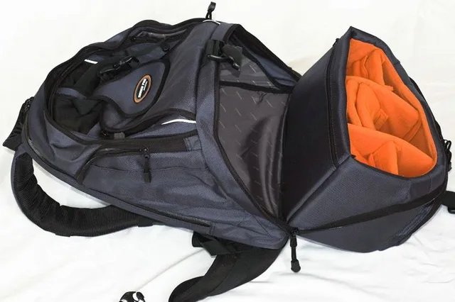 To open the lower compartment  there is a combination of a quick release buckle and a zipper hidden under a flap for added security