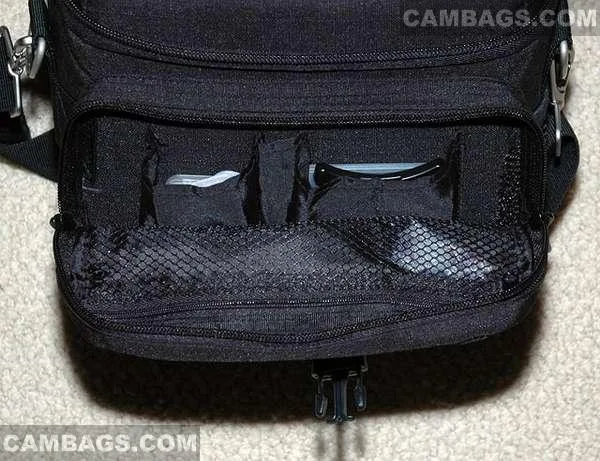 First, into the front pouch I can pack the extra CF card, lens wipe, gel kit, flash stand, and a silica get