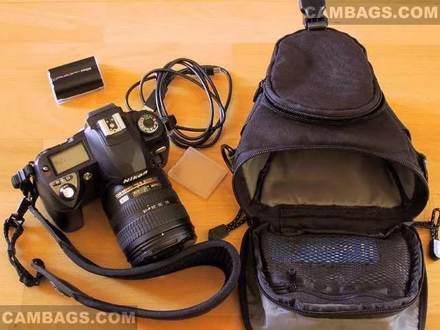 Ok, this is the stuff I keep in mine: Nikon D70 with kit lens (or 50mm), Spare battery, spare CF-card and USB-cable.