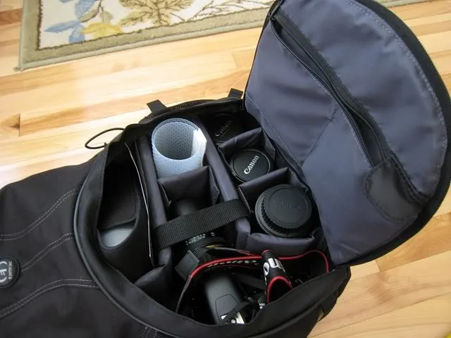 All the camera stuff are in the main bottom compartment. The filter, cards, cleaning kit stored in the top compartment. The SD cards, battery is stored in the pocket (the grey panel) in the bottom compartment.  Look, I can store my camera with lens hood on my Tamron lens and I still have space left (the slot where I put my DIY diffuser)