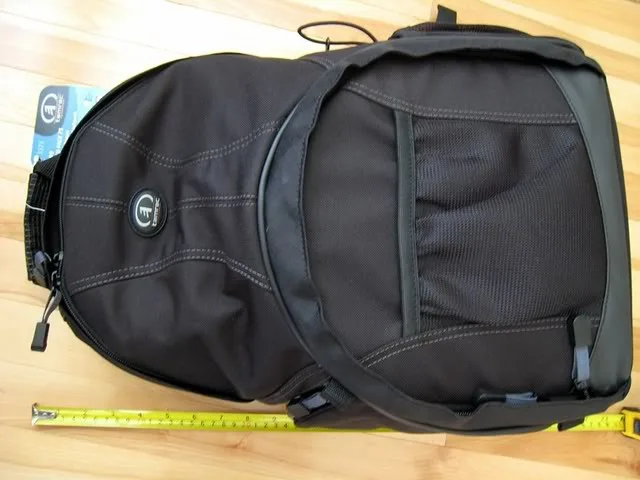 The camera bag looks is perfect. Not fancy that will attract a lot of attention. It looks also like just normal backpack. It is not huge. So no worry that you will bump people unless it is really crowded