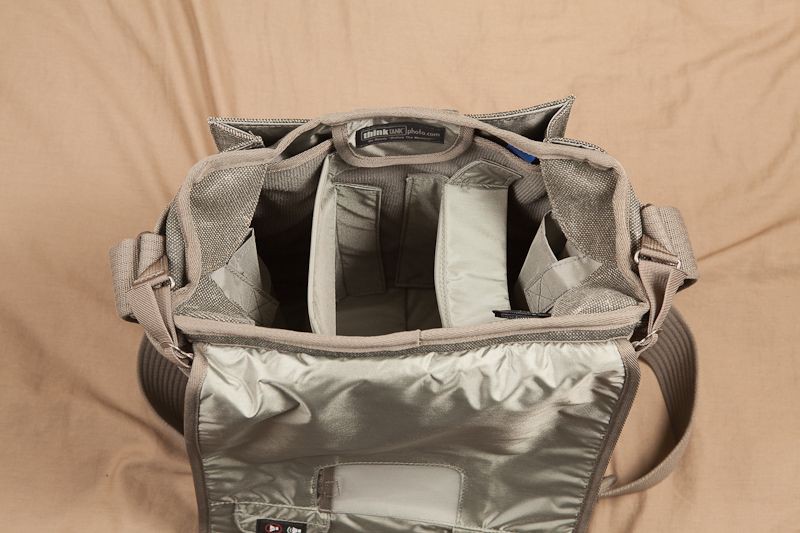 The inside of the bag is completely customizable. With the dividers provided (3 large and 2 small), it would be possible to set this bag up in a multitude of different ways. The tops of the large dividers are able to fold to any angle to provide for camera support or to completely partition off a section of the bag.