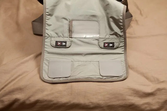 As you can see, it has yet another bigger velcro pocket on the front for larger things. Later In the review I’ll show you what I keep in there.  One really nice feature about almost all the Velcro on this bag is that it’s essentially optional. The pockets all have an outer Velcro strip so you can close the pocket and in inner strip so you can keep it open and access your gear without hearing a huge ripping sound. The main flap has this feature too (dubbed “sound silencer”). You just undo the Velcro and flip it over on itself (pictured below). This way the bag is completely silent. You can also just fold up one strip so the bag becomes a littl